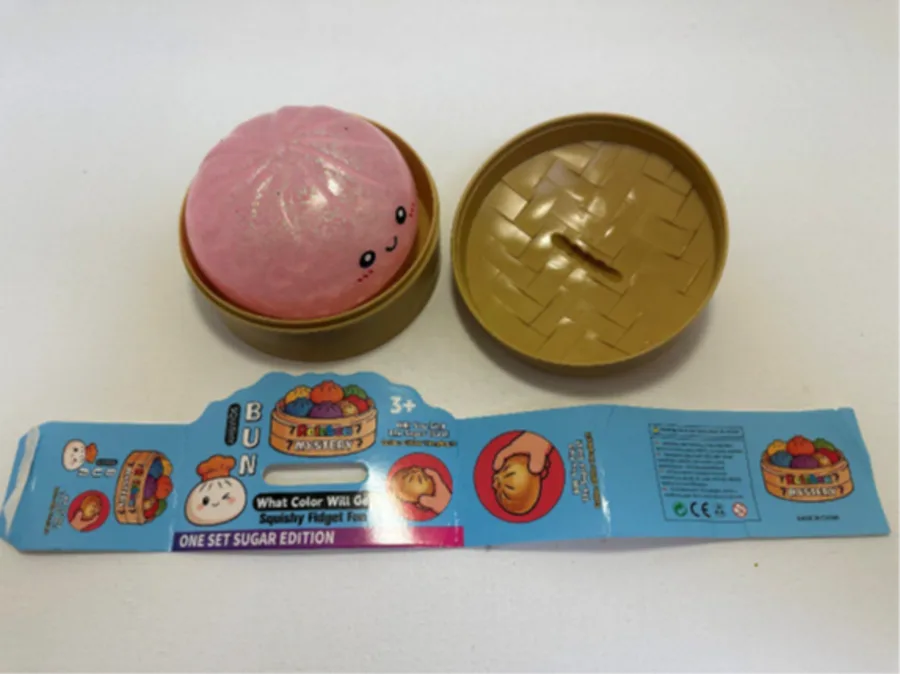 Recalled Rainbow Mystery Squishy Bun, tan container and packaging